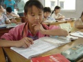 120px-A girl studies in a school in Lanzhou, Gansu Province, temporarily because she lacks local household registration (hukou). This kind of students are called Jiedusheng in Chinese..JPEG